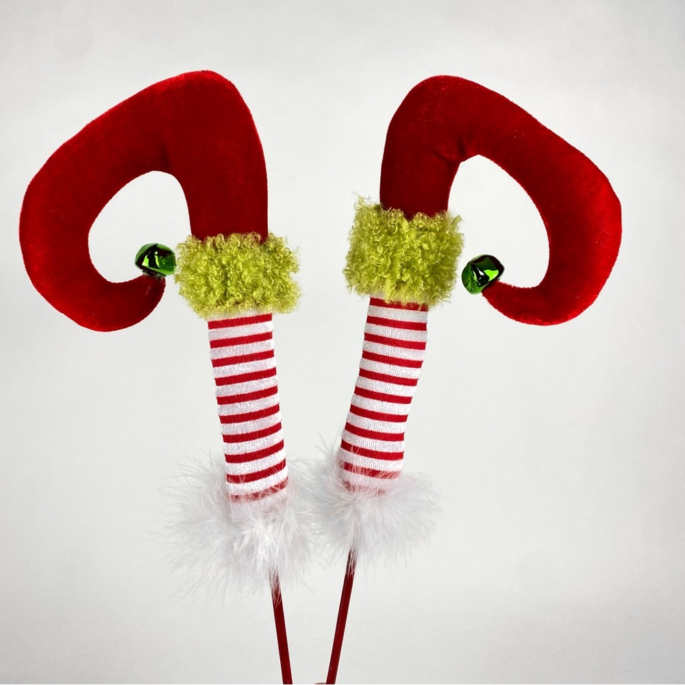 Christmas Elf Legs with White Feathers on a Red Stick